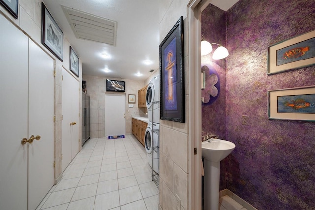 1835 Alicia Way, Clearwater, FL 33764 - bathroom with estacked washer and dryer and tile patterned flooring