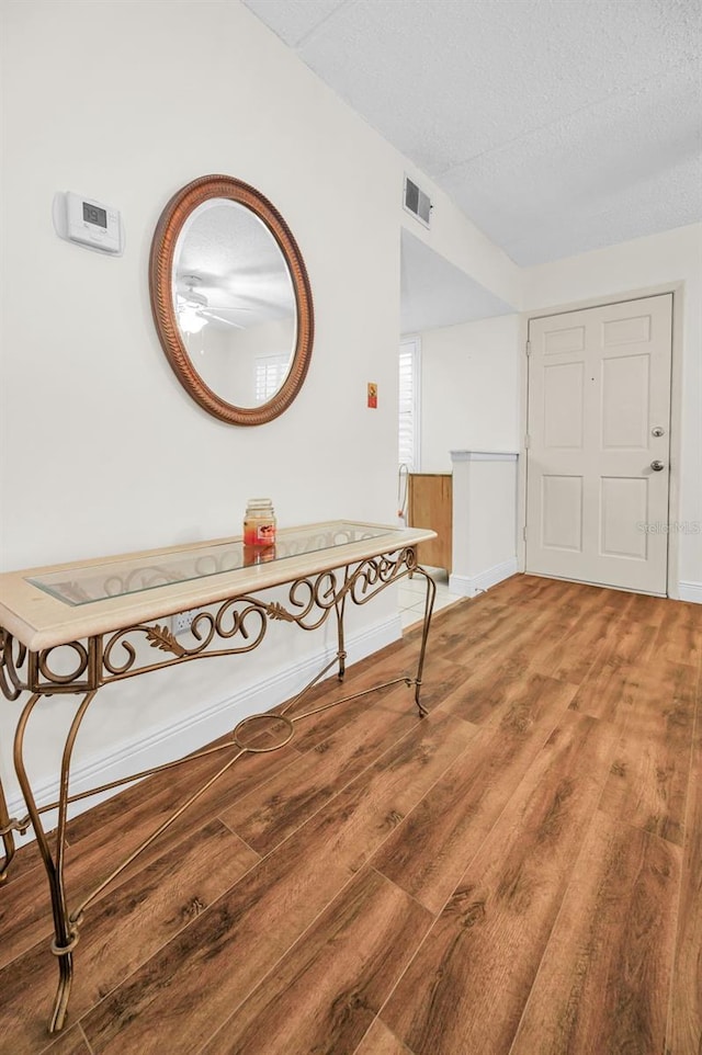 920 Virginia St Unit 204, Dunedin, FL 34698 - entryway with light wood-style flooring, a ceiling fan, and a textured ceiling