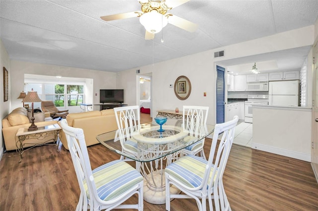 920 Virginia St Unit 204, Dunedin, FL 34698 - dining area featuring wood finished floors, a ceiling fan, and a textured ceiling
