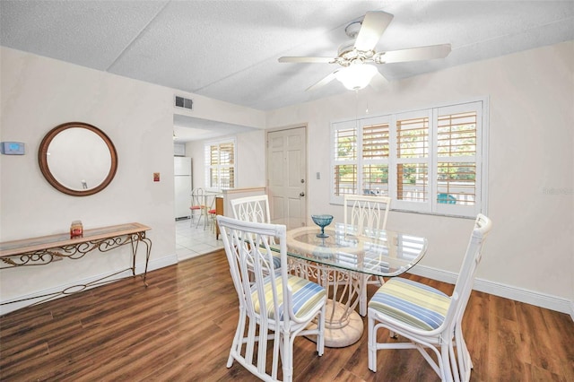 920 Virginia St Unit 204, Dunedin, FL 34698 - dining space featuring ceiling fan, wood finished floors, and a textured ceiling