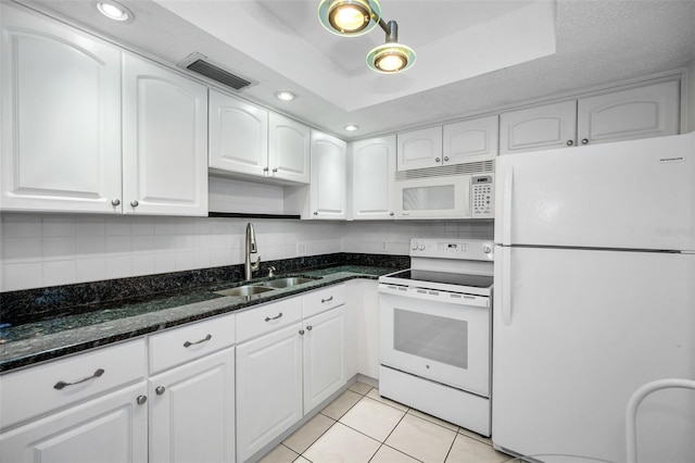 920 Virginia St Unit 204, Dunedin, FL 34698 - kitchen with white appliances, dark stone countertops, white cabinetry, backsplash, and recessed lighting
