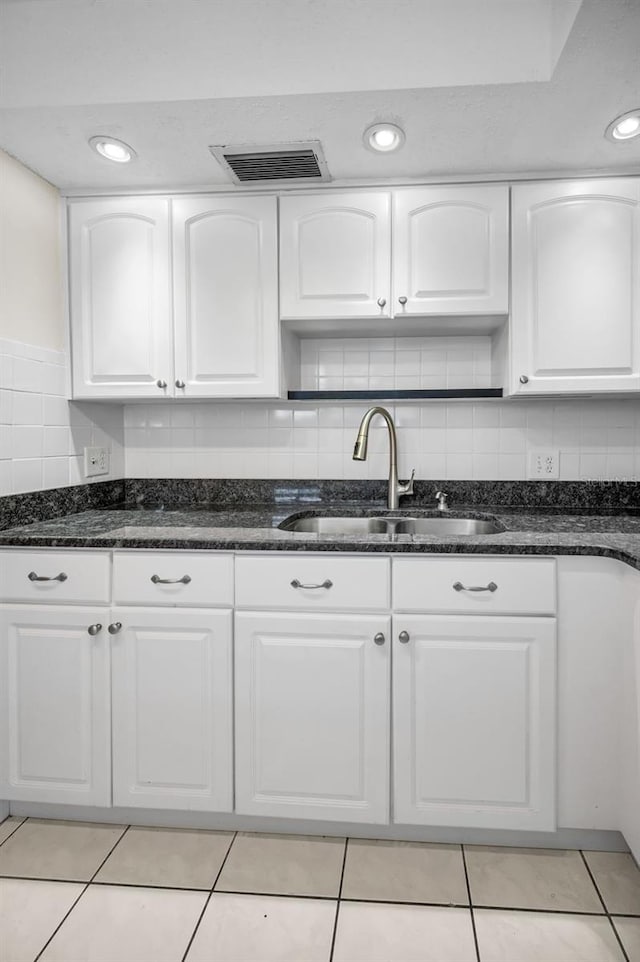 920 Virginia St Unit 204, Dunedin, FL 34698 - kitchen with dark stone countertops, white cabinets, open shelves, and light tile patterned floors