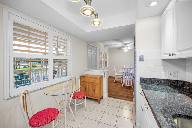 920 Virginia St Unit 204, Dunedin, FL 34698 - kitchen with light tile patterned floors, white cabinetry, dark stone counters, a ceiling fan, and recessed lighting