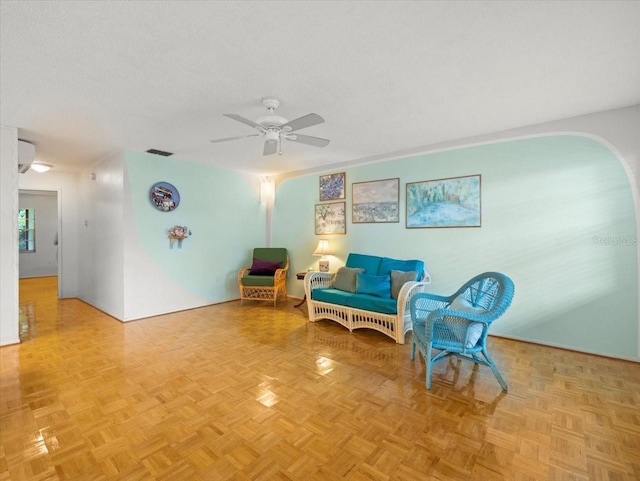 2357 Walton Cir Unit M6, Palm Harbor, FL 34683 - living area with a ceiling fan, arched walkways, and a textured ceiling