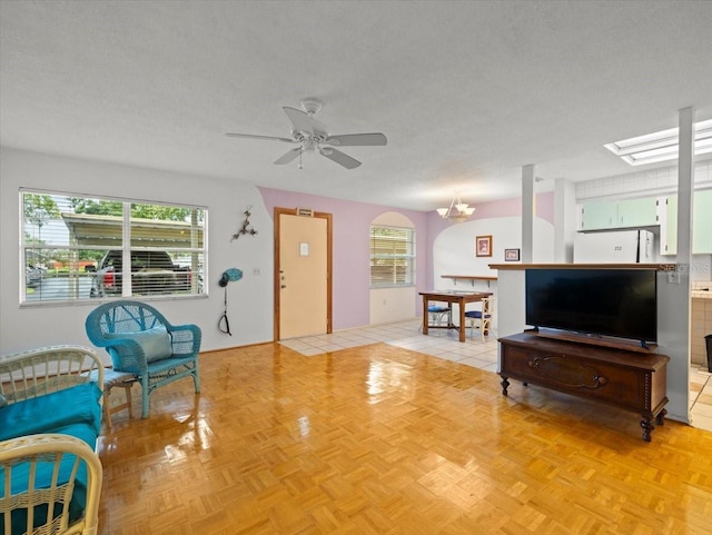 2357 Walton Cir Unit M6, Palm Harbor, FL 34683 - living room featuring healthy amount of natural light, a ceiling fan, and a textured ceiling