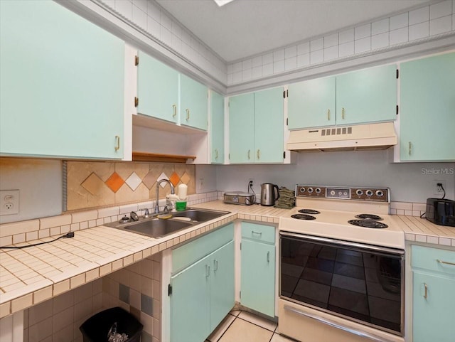 2357 Walton Cir Unit M6, Palm Harbor, FL 34683 - kitchen with white electric range, under cabinet range hood, open shelves, light countertops, and backsplash
