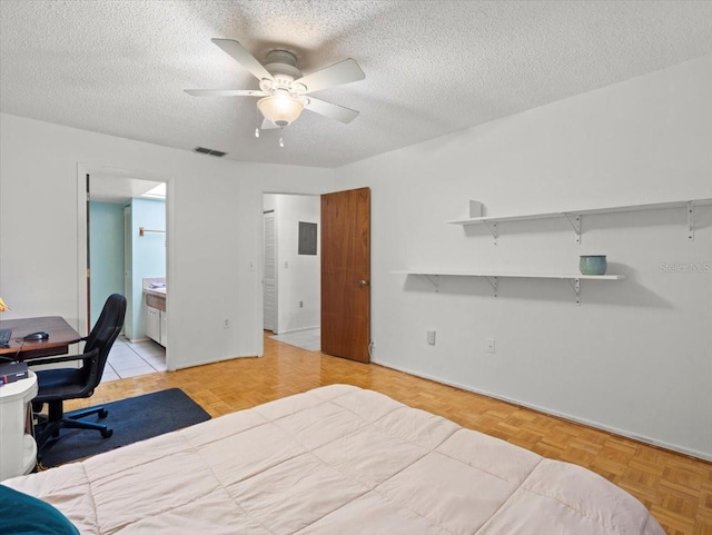 2357 Walton Cir Unit M6, Palm Harbor, FL 34683 - bedroom with a textured ceiling, ensuite bathroom, and ceiling fan