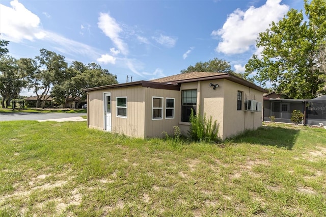 271 Eastpoint Ct, Spring Hill, FL 34606 - view of side of property with a yard, cooling unit, and a sunroom