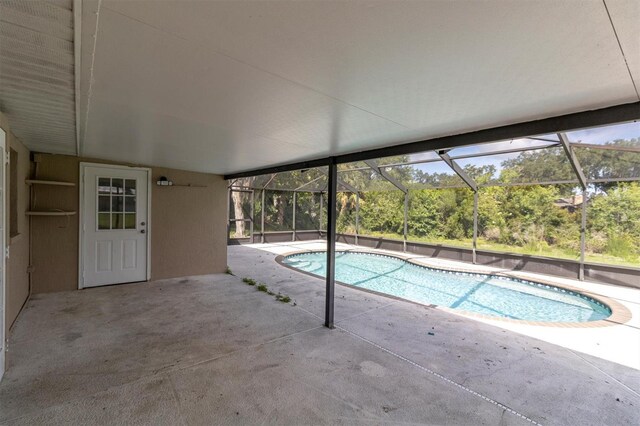 271 Eastpoint Ct, Spring Hill, FL 34606 - outdoor pool featuring a patio and glass enclosure