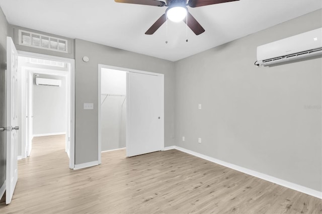 271 Eastpoint Ct, Spring Hill, FL 34606 - unfurnished bedroom featuring a wall mounted air conditioner, light wood-type flooring, and a closet