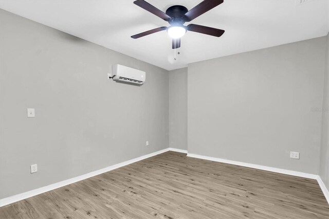 271 Eastpoint Ct, Spring Hill, FL 34606 - empty room featuring a wall unit AC, ceiling fan, and wood finished floors