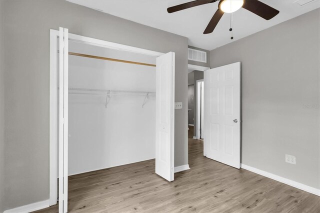 271 Eastpoint Ct, Spring Hill, FL 34606 - unfurnished bedroom featuring wood finished floors, a closet, and a ceiling fan