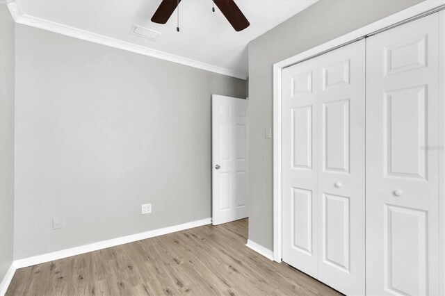 271 Eastpoint Ct, Spring Hill, FL 34606 - unfurnished bedroom featuring a closet, crown molding, light wood-style flooring, and ceiling fan