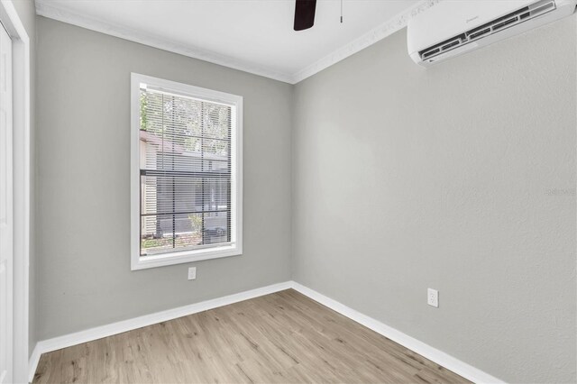 271 Eastpoint Ct, Spring Hill, FL 34606 - empty room featuring a wall mounted AC, light wood-style floors, a ceiling fan, and ornamental molding