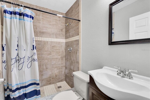 271 Eastpoint Ct, Spring Hill, FL 34606 - bathroom featuring a tile shower, vanity, and a textured wall