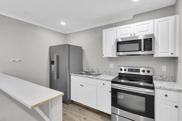 271 Eastpoint Ct, Spring Hill, FL 34606 - kitchen featuring appliances with stainless steel finishes, light wood finished floors, white cabinetry, and recessed lighting
