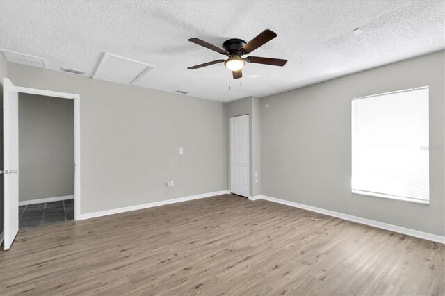 271 Eastpoint Ct, Spring Hill, FL 34606 - spare room featuring a textured ceiling, wood finished floors, attic access, and ceiling fan