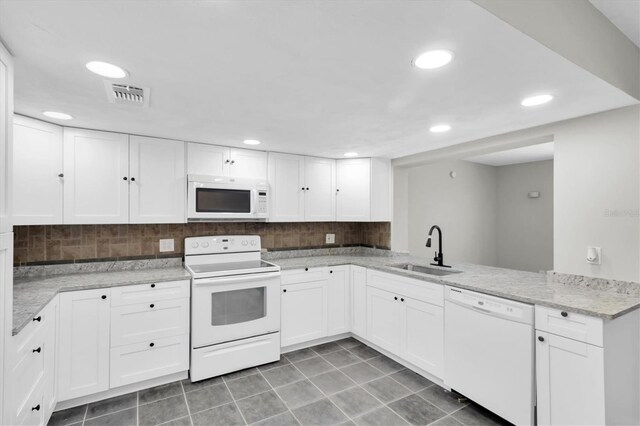 271 Eastpoint Ct, Spring Hill, FL 34606 - kitchen with white appliances, decorative backsplash, white cabinetry, light stone countertops, and recessed lighting