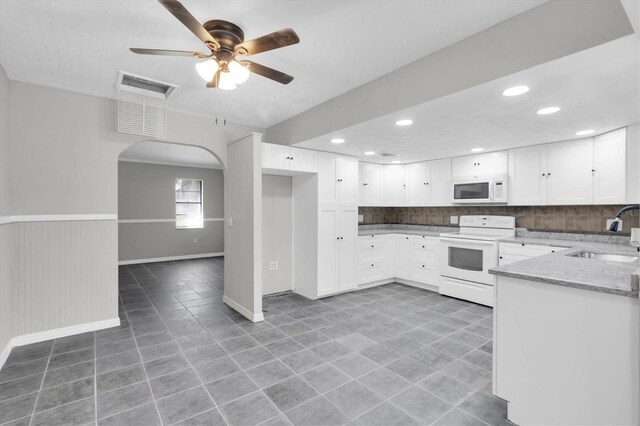 271 Eastpoint Ct, Spring Hill, FL 34606 - kitchen featuring white appliances, light stone counters, backsplash, white cabinets, and light tile patterned floors