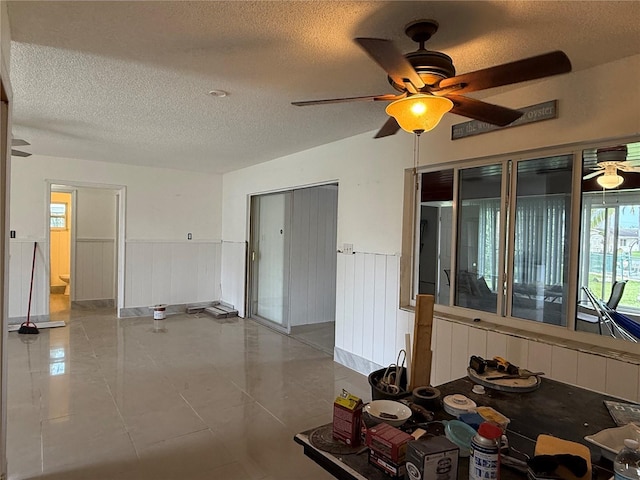 6711 Arroyo Dr, New Port Richey, FL 34652 - spare room with a ceiling fan, a textured ceiling, and a wainscoted wall
