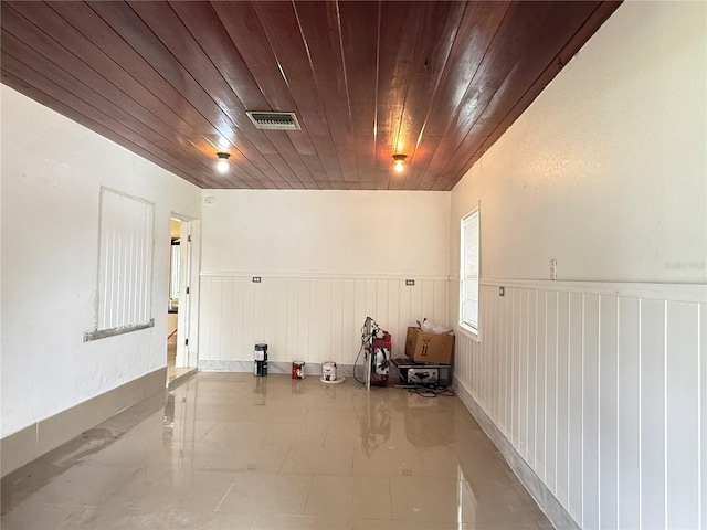 6711 Arroyo Dr, New Port Richey, FL 34652 - garage with wooden ceiling and a wainscoted wall