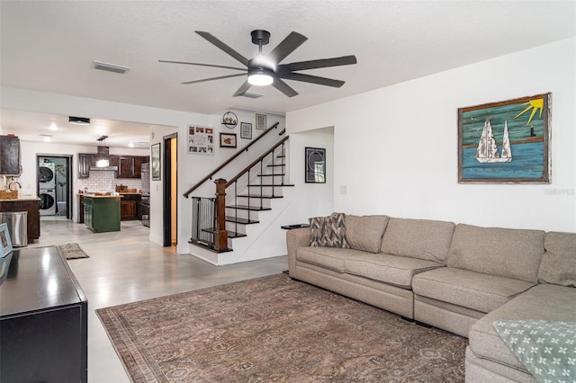 11414 Donneymoor Dr, Riverview, FL 33569 - living room featuring stacked washing machine and dryer, a ceiling fan, and stairs