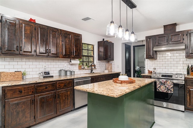 11414 Donneymoor Dr, Riverview, FL 33569 - kitchen featuring appliances with stainless steel finishes, under cabinet range hood, a kitchen island, and tasteful backsplash