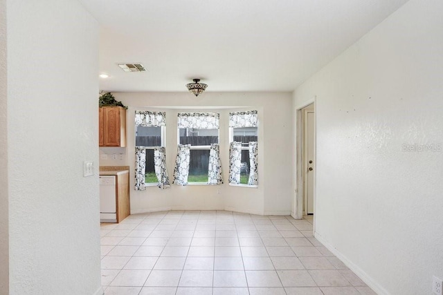 7841 Royal Stewart Dr, New Port Richey, FL 34653 - unfurnished living room with baseboards and light tile patterned floors