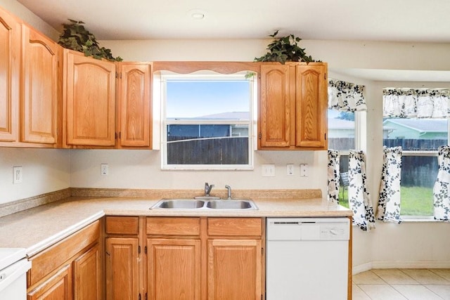 7841 Royal Stewart Dr, New Port Richey, FL 34653 - kitchen featuring dishwasher, light countertops, range, and light tile patterned floors
