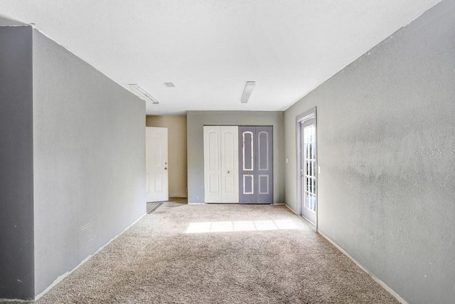 7841 Royal Stewart Dr, New Port Richey, FL 34653 - unfurnished bedroom with light colored carpet and a closet