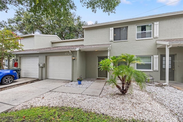 1724 Adams Cir S, Largo, FL 33771 - view of property with stucco siding, a garage, and driveway