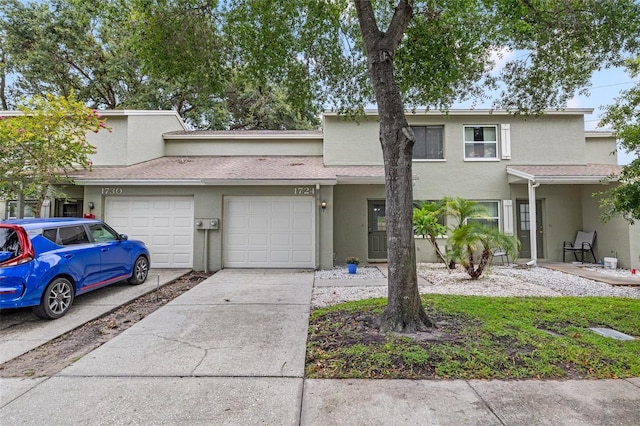 1724 Adams Cir S, Largo, FL 33771 - multi unit property with stucco siding, concrete driveway, and an attached garage