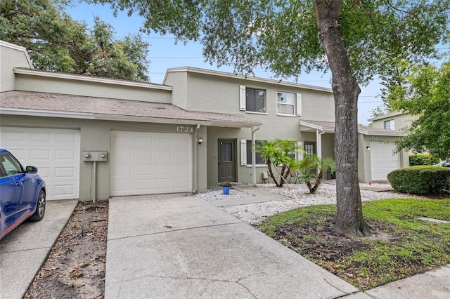 1724 Adams Cir S, Largo, FL 33771 - townhome / multi-family property featuring stucco siding, concrete driveway, and a garage