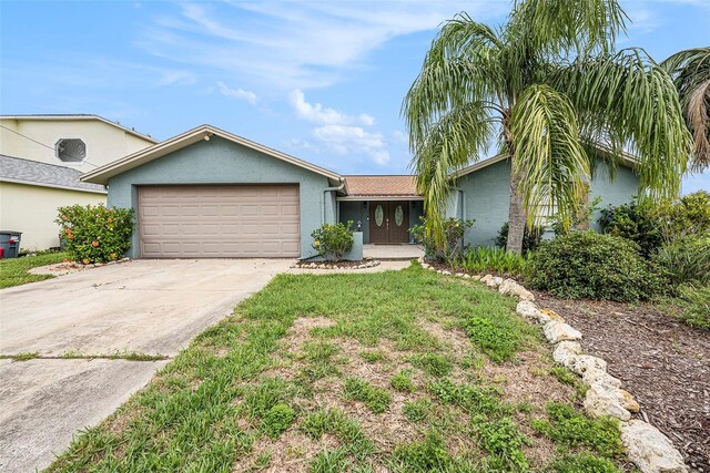 15525 Old Dixie Hwy, Hudson, FL 34667 - ranch-style home featuring stucco siding, an attached garage, and driveway