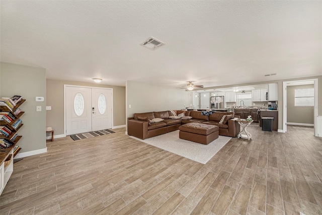 15525 Old Dixie Hwy, Hudson, FL 34667 - living room with light wood finished floors, ceiling fan, and healthy amount of natural light