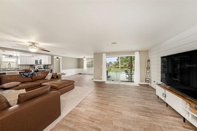 15525 Old Dixie Hwy, Hudson, FL 34667 - living area featuring a ceiling fan and light wood-style floors