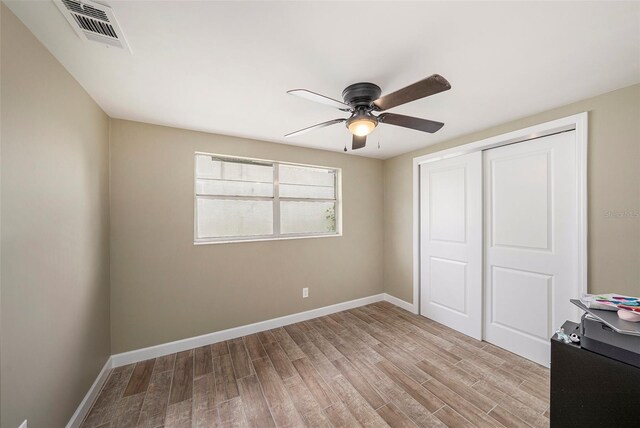 15525 Old Dixie Hwy, Hudson, FL 34667 - unfurnished bedroom featuring wood finished floors, a closet, and a ceiling fan