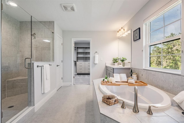 14626 Horse Trot Rd, Lithia, FL 33547 - bathroom featuring vanity, a stall shower, a garden tub, and a walk in closet