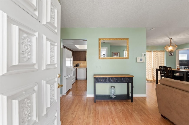 9171 Horizon Dr, Spring Hill, FL 34608 - hall featuring light wood finished floors and a textured ceiling