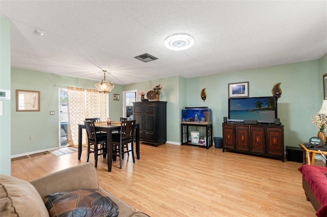 9171 Horizon Dr, Spring Hill, FL 34608 - dining room with light wood-style flooring and a textured ceiling