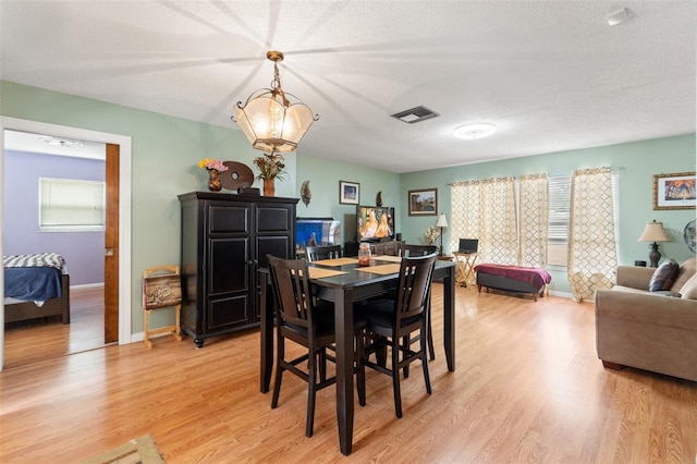 9171 Horizon Dr, Spring Hill, FL 34608 - dining space featuring light wood finished floors and a textured ceiling