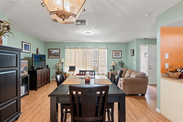 9171 Horizon Dr, Spring Hill, FL 34608 - dining room featuring light wood finished floors and a textured ceiling