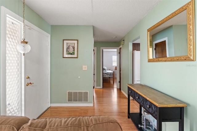 9171 Horizon Dr, Spring Hill, FL 34608 - entryway with wood finished floors and a textured ceiling