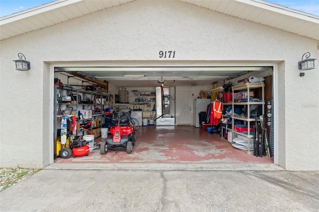 9171 Horizon Dr, Spring Hill, FL 34608 - garage with freestanding refrigerator