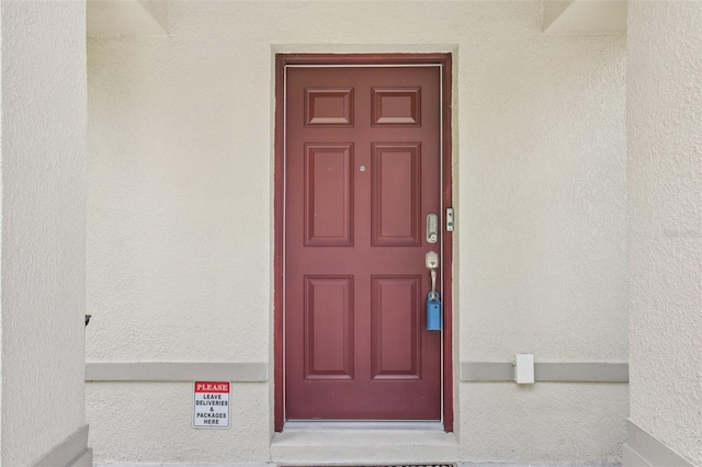 14509 Mayer Ave, Hudson, FL 34669 - view of exterior entry with stucco siding