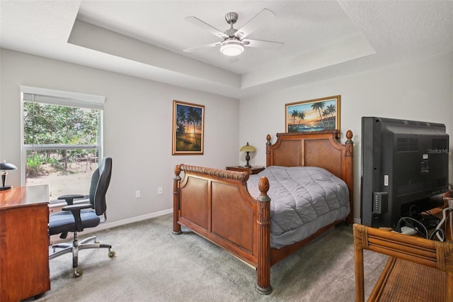 14509 Mayer Ave, Hudson, FL 34669 - bedroom with a tray ceiling, light colored carpet, an office area, and a ceiling fan