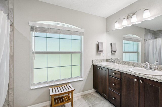 14509 Mayer Ave, Hudson, FL 34669 - full bathroom with double vanity, marble finish flooring, and a shower with curtain