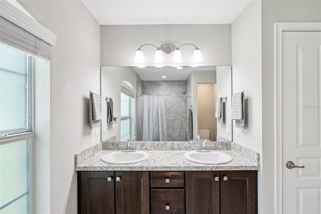 14509 Mayer Ave, Hudson, FL 34669 - bathroom featuring tiled shower and double vanity
