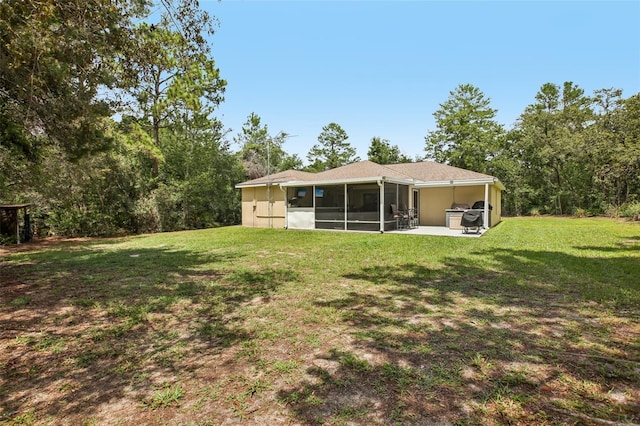 14509 Mayer Ave, Hudson, FL 34669 - back of house featuring a sunroom, a yard, and a patio area
