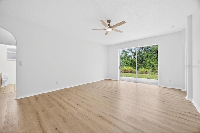 1760 Mountclair Ct, Mount Dora, FL 32757 - empty room featuring a ceiling fan, light wood-style floors, and arched walkways